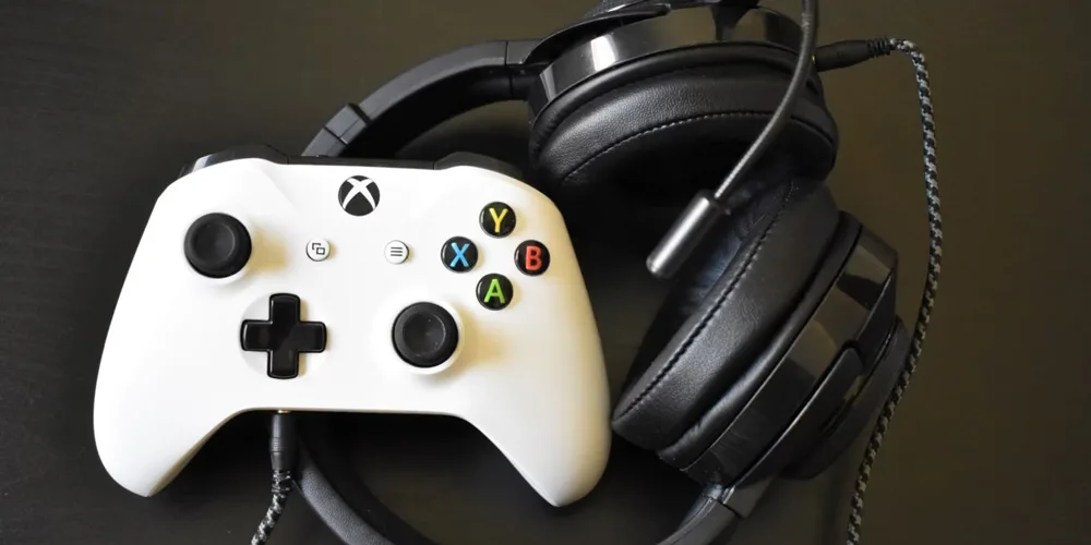 an xbox controller with a pair of headphones jpg