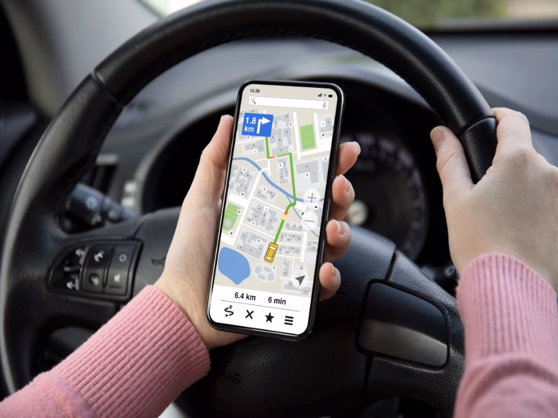 a woman using a maps app on android while driving